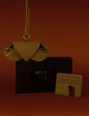 Close-up of open leather gift box showing sunglass case and card holder.