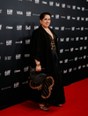 Guneet Monga in Black Zoran Clutch