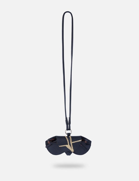 Close-up shot of a hand holding a protective full-grain leather sunglass case with a secure magnetic flap